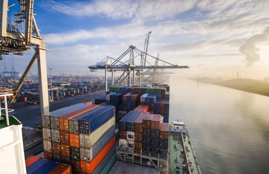 Sunrise in busy container terminal in Rotterdam, Netherlands.